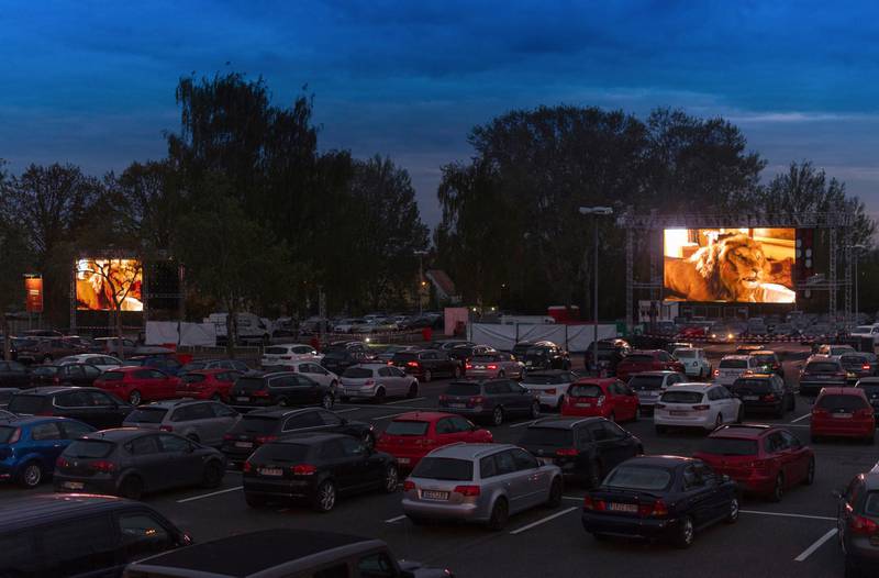 Numerous cars are parked in front of screens at a drive-in cinema for the film 'Jumanji' in Dresden, Saxony, Germany. dpa via AP