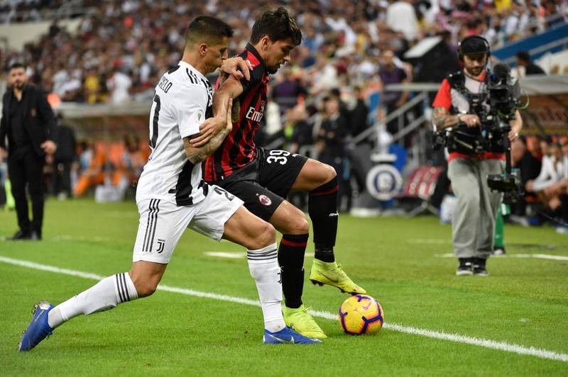 AC Milan's Brazilian midfielder Lucas Paqueta, right, is challenged by Joao Cancelo. AFP