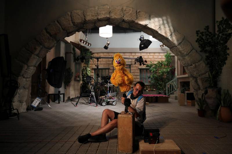 A puppeteer from the children's programme 'Ahlan Simsim' holds the main puppet Jad, six years old, during an interview with Reuters TV after filming a scene on the set of the show in a studio in Amman, Jordan. Reuters