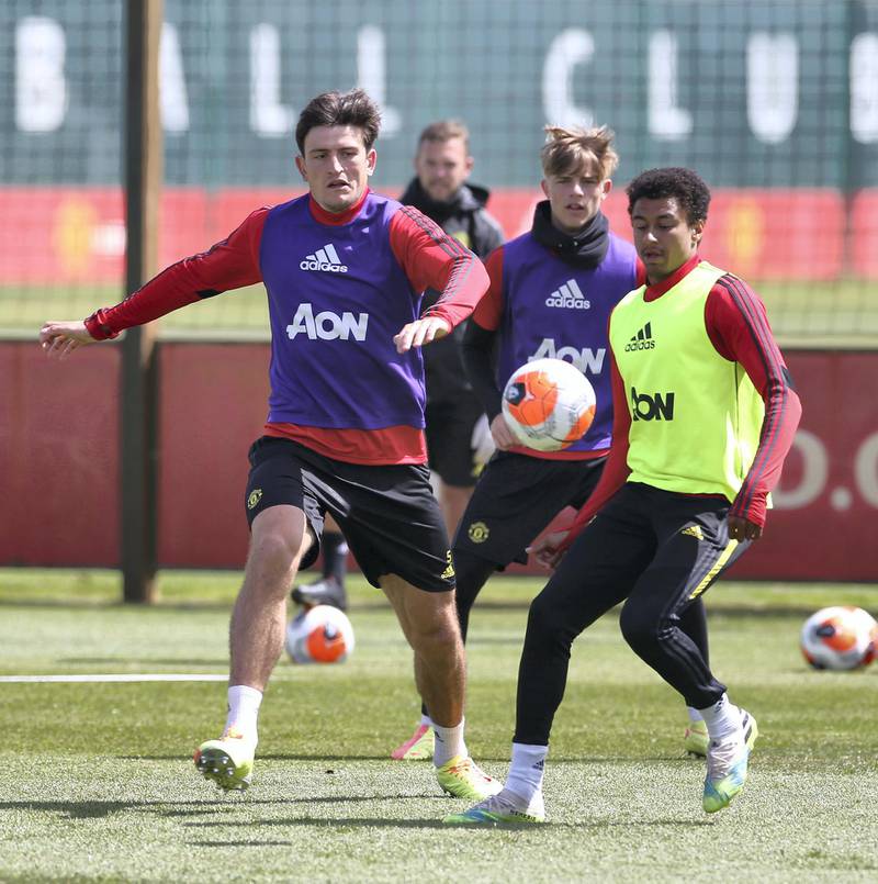 MANCHESTER, ENGLAND - JUNE 05: Harry Maguire and Jesse Lingard of Manchester United in action during a first team training session at Aon Training Complex on June 05, 2020 in Manchester, England. (Photo by Matthew Peters/Manchester United via Getty Images)