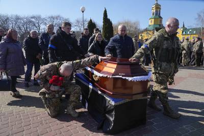 Ukrainian soldiers pay tribute to Col Valeriy Gudz, who was killed in battle against Russian troops, at a cemetery in the town of Boryspil. AP