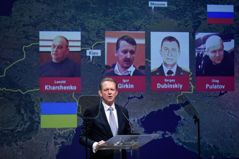 Chief Prosecutor with the National Prosecutor's Office of the Netherlands Fred Westerbeke delivers a speech during a press conference of the Joint Investigation Team on June 19, 2019 in Nieuwegein, on the ongoing investigation of the Malaysia Airlines MH17 crash in 2014, next to the pictures of (from LtoR) Ukrainian Leonid Kharchenko, former FSB colonel Igor Girkin (Strelkov), Sergei Dubinsky employed by Russia's GRU military intelligence agency and former soldier of the Spetznaz GRU Oleg Pulatov. The Dutch-led probe said it was going to prosecute Russian nationals Girkin, Sergei Dubinsky and Oleg Pulatov as well as Ukrainian Leonid Kharchenko, adding they would be placed on national and international wanted lists, over the downing of the Malaysia Airlines plane in July, 2014 when it was shot out of the sky by a BUK missile. / AFP / JOHN THYS
