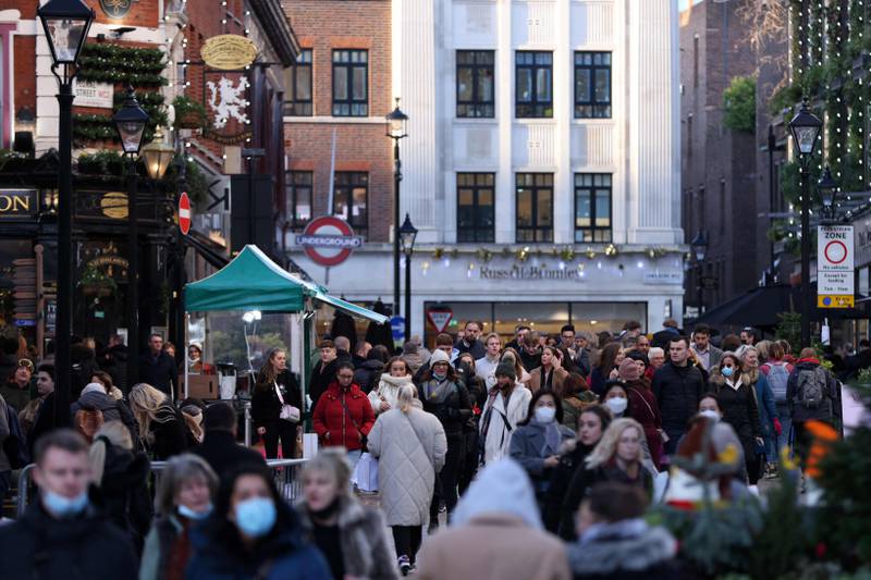Many shoppers in Covent Garden, central London, fail to wear face masks on December 9. AFP