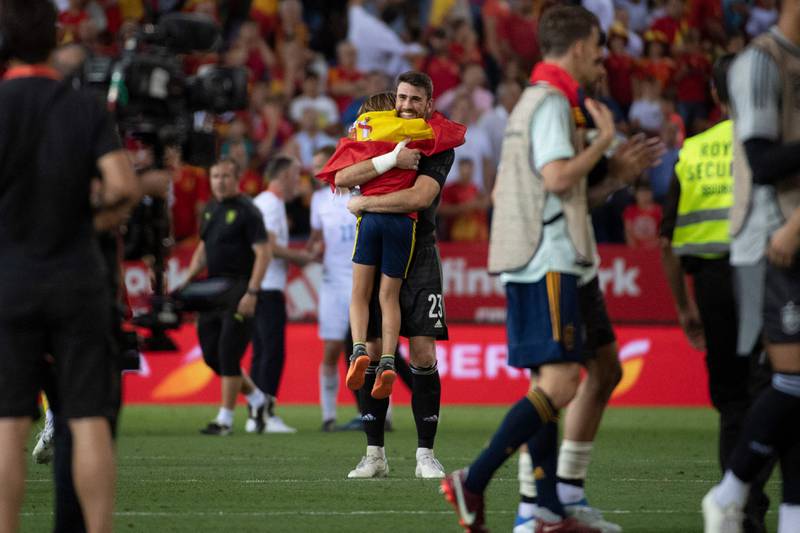 Spain goalkeeper Unai Simon hugs a young fan at the final whistle. AFP