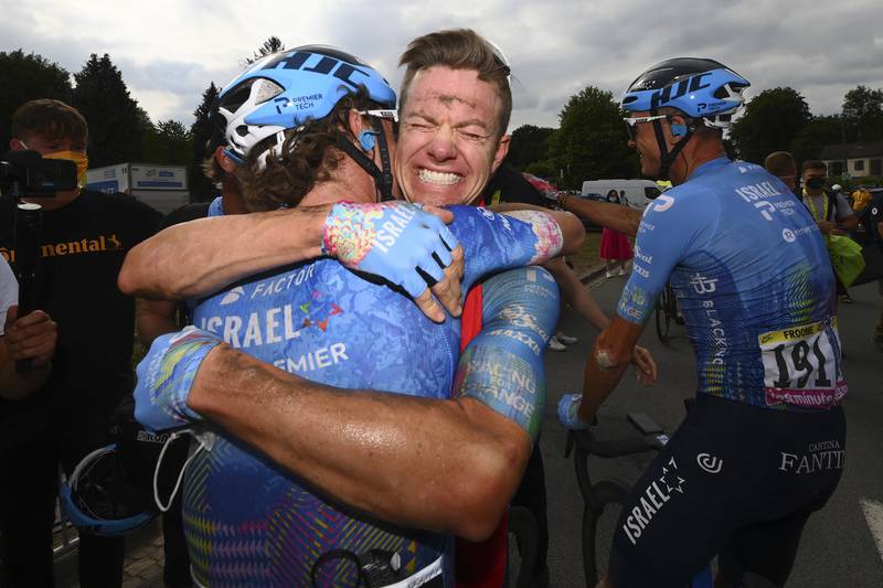 Stage winner Simon Clarke centre, is congratulated by a teammate. AP