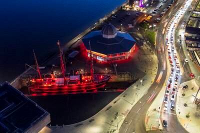 The RRS Discovery and Discovery Point in Dundee are illuminated in red light for the Light Up Red campaign. PA
