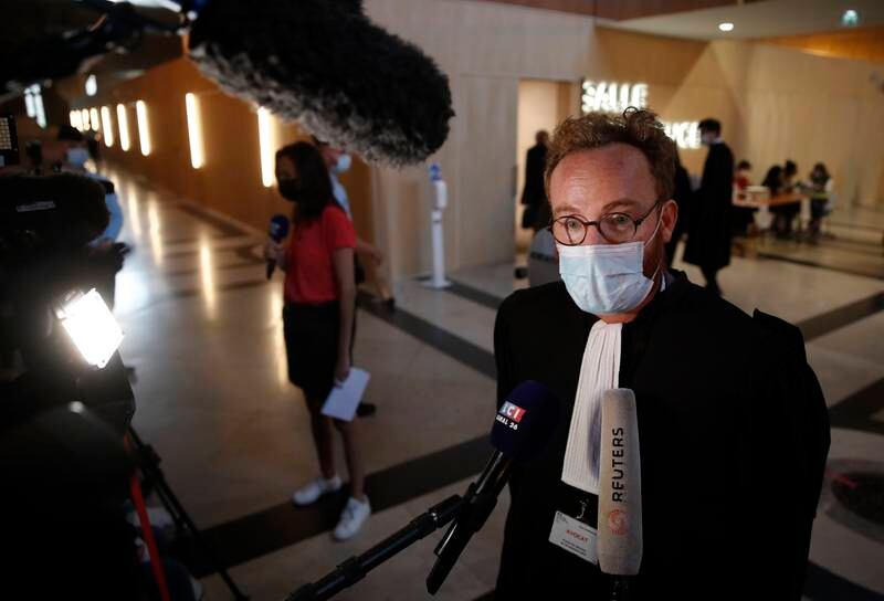Victour Edou, the victims' lawyer, speaks to the press at the trial. EPA