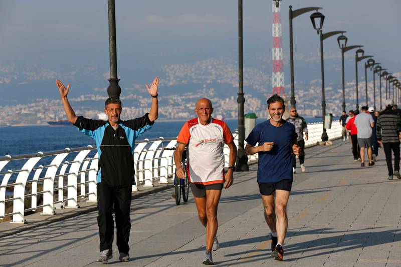 Runners smile and react to having their picture taken as they run on Beirut's corniche, along the Mediterranean Sea. AP