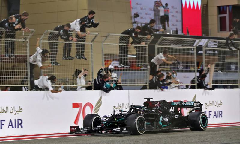 Mercedes' driver Lewis Hamilton is cheered by his team after winning in Bahrain. AFP