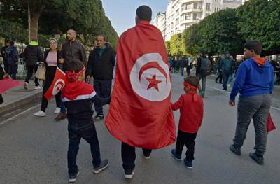 Tunisians take part in a rally marking the ninth anniversary of the 2011 uprising, at Habib Bourguiba Avenue in Tunis on January 14, 2020. AFP