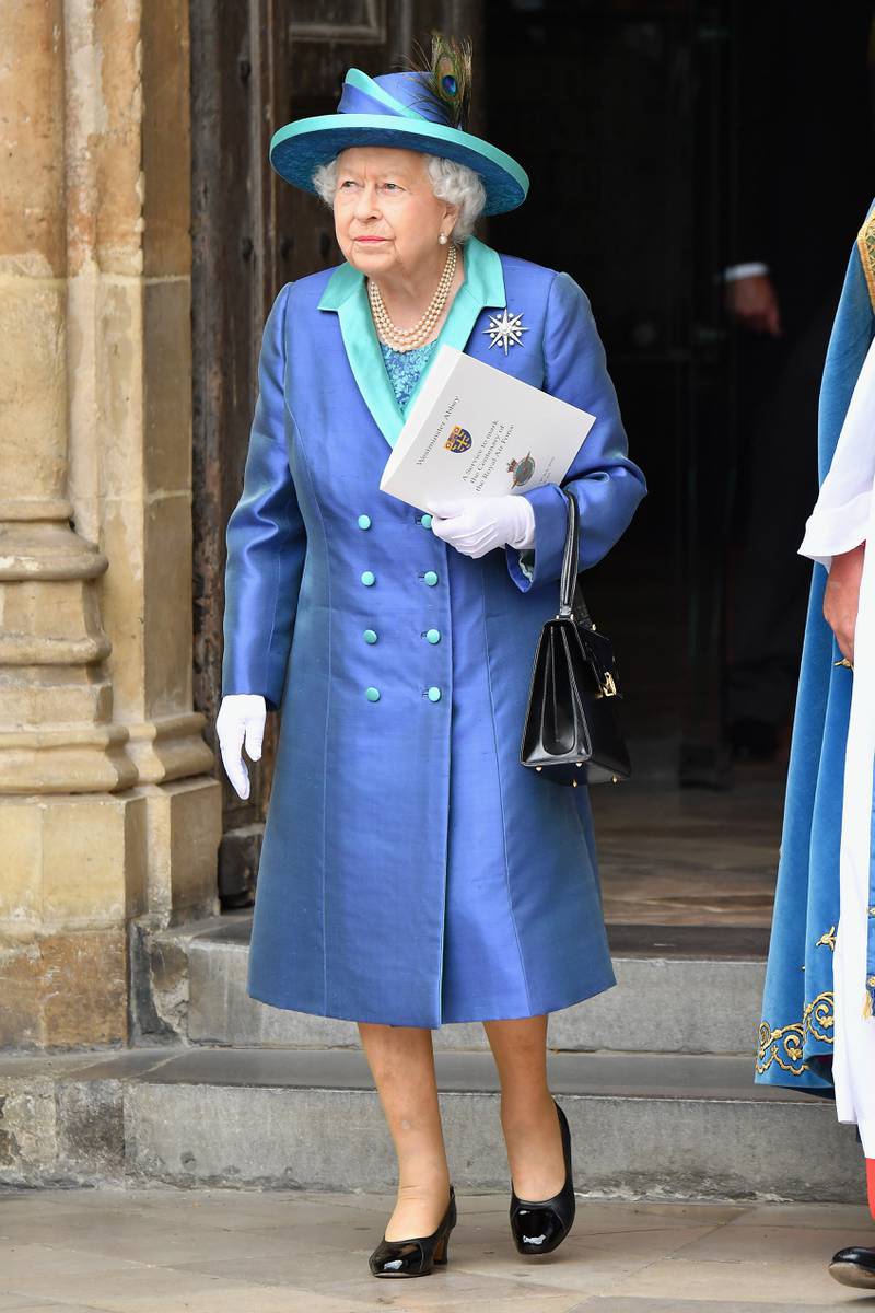 Queen Elizabeth II, in blue, attends events to mark the centenary of the RAF on July 10, 2018, in London. Getty Images