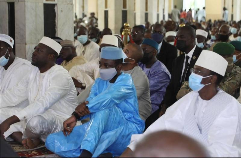 Mali's interim president, Col Assimi Goita, in blue, during Eid Al Adha prayers before he was attacked by armed men. AFP