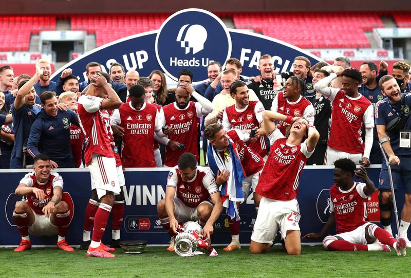 Arsenal players react after Pierre-Emerick Aubameyang  drops the FA Cup during the celebrations. Getty