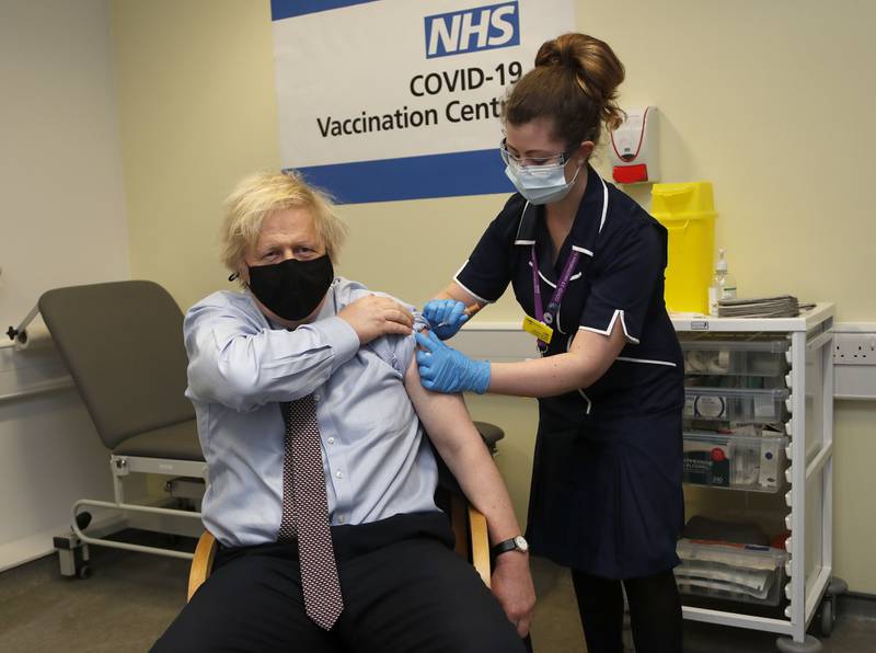 Mr Johnson receives his first dose of the AstraZeneca vaccine at St. Thomas' Hospital in London, in March 2021. Getty Images