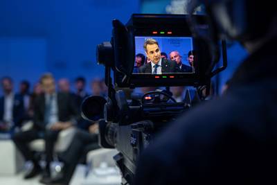 Mr Mitsotakis is seen on a TV camera viewfinder at the Congress Centre in Davos. AFP
