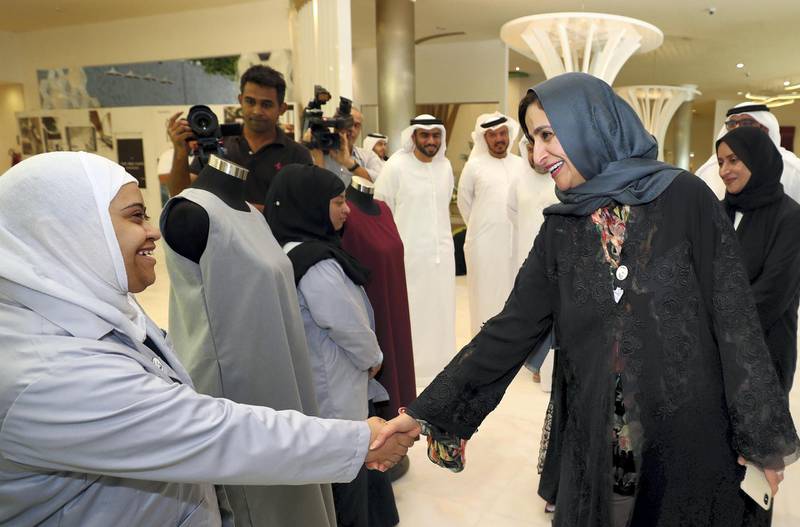 Abu Dhabi, United Arab Emirates - June 27, 2019: Mariam Alhosany one of the students that makes the uniforms meets HE Jameela Bint Salem Mesbeh Al Muhairi, cabinet member and minister of state for public education. An initiative where people of special needs will be making school uniforms. Thursday the 27th of June 2019. Zayed higher organisation, Abu Dhabi. Chris Whiteoak / The National