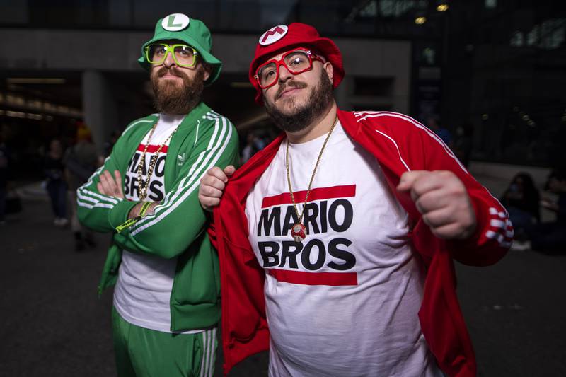 Cosplayers as video game characters Luigi and Mario pose during New York Comic Con. Charles Sykes / Invision / AP