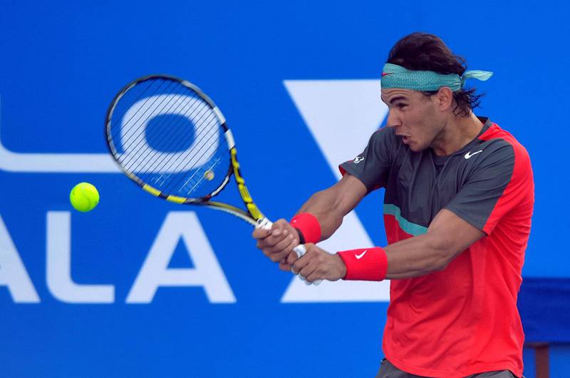 Spain's Rafael Nadal returns the ball to his compatriot David Ferrer during their semi final match on the second day of the Mubadala World Tennis Championship in the Emirati capital Abu Dhabi on December 27, 2013. AFP PHOTO/INEKE ZONDAG (Photo by INEKE ZONDAG / AFP)