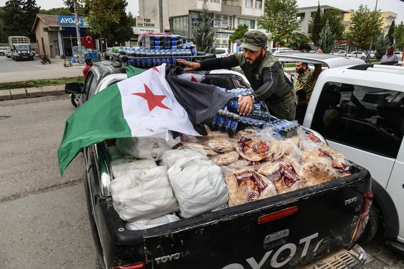 Members of Turkish-backed Free Syrian Army, a militant group active in parts of northwest Syria, load their goods after shopping from a market to their vehicle in Akcakale, Turkey. The military action is part of a campaign to extend Turkish control of more of northern Syria, a large swath of which is currently held by Syrian Kurds, whom Turkey regards as a threat. U.S. President Donald Trump granted tacit American approval to this campaign, withdrawing his country's troops from several Syrian outposts near the Turkish border. Getty Images