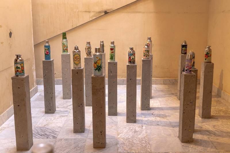 'Holy Economy' (2019), with metal bottles used by pilgrims installed on cement blocks. Image courtesy Athr and the artist