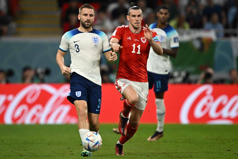 Luke Shaw and Wales'  Gareth Bale fight for the ball. AFP