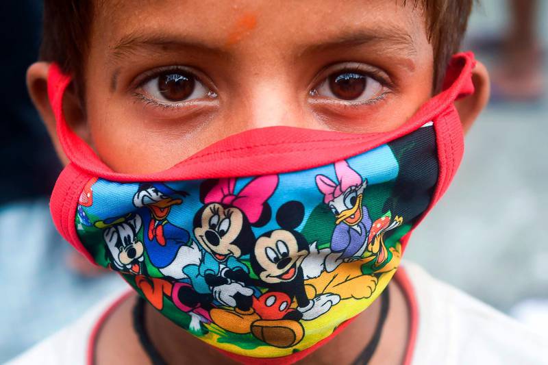 A child wears a face mask depicting Disney characters amid concerns over the spread of the Covid-19 coronavirus, in Kolkata, India. AFP