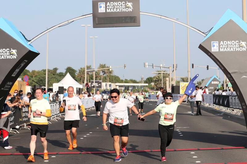 Participants complete the  ADNOC Abu Dhabi Marathon.