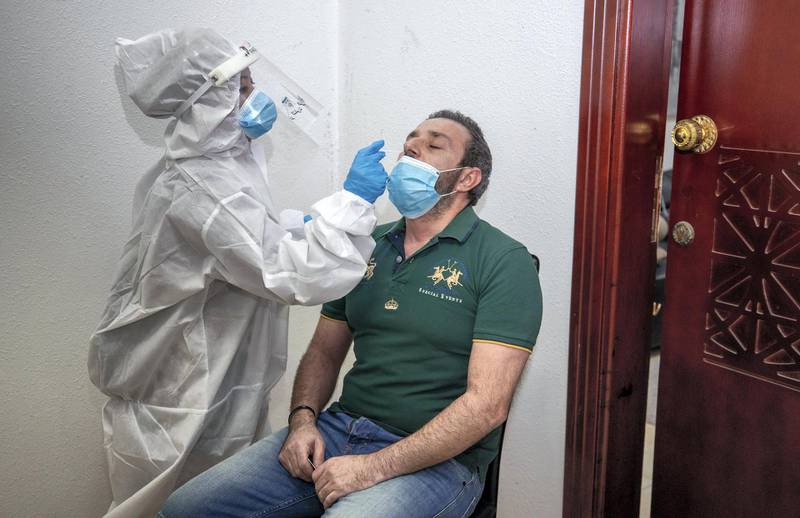 Abu Dhabi, United Arab Emirates, June 22, 2020.   STORY BRIEF: Police patrols knocking on doors offering free Covid-19 tests to residents in buildings in AD downtown, Al Bakra Street area.--  Building resident Ziad Marchi-42 from Lebanon gets a swab test.Victor Besa  / The NationalSection:  NAReporter:  Haneen Dajani