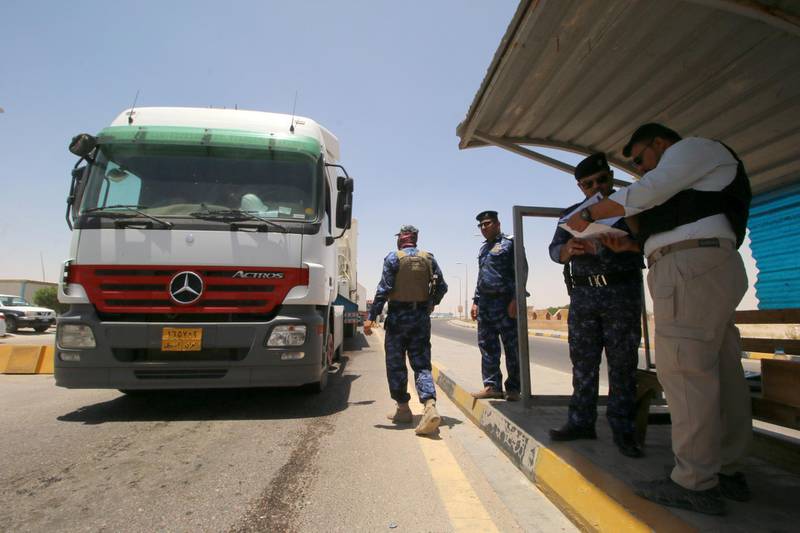 Security officers stay guard at the entry of Zubair oilfield. Reuters