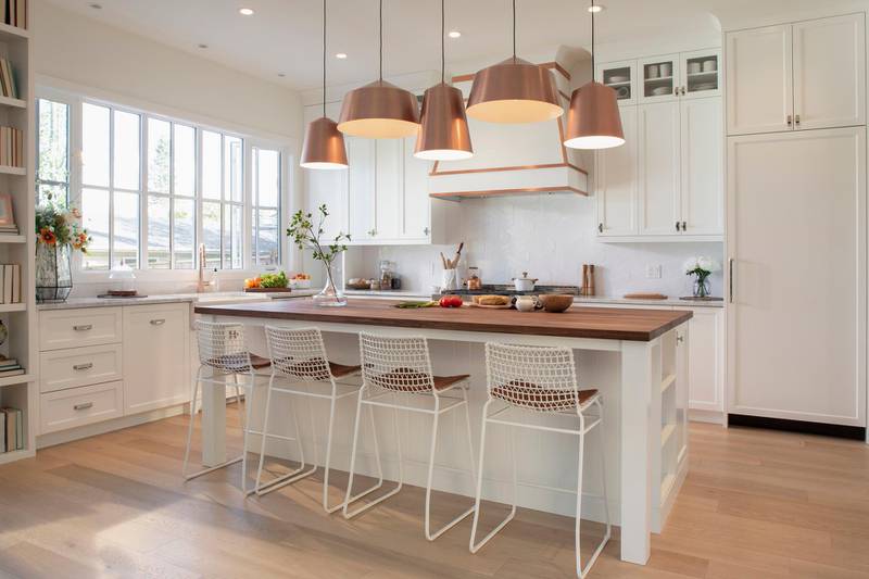 White home showcase interior kitchen with copper pendant lights. Getty Images