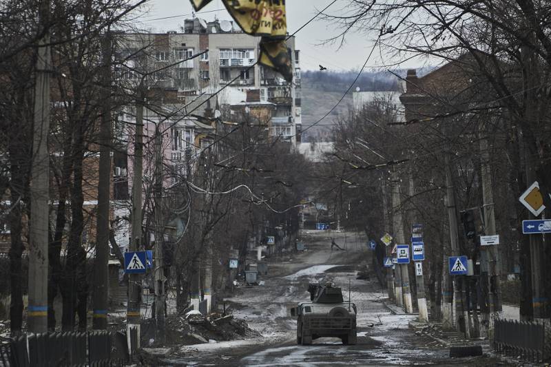 Ukrainian soldiers ride in a military vehicle in Bakhmut, a city in the Donetsk enclave. AP
