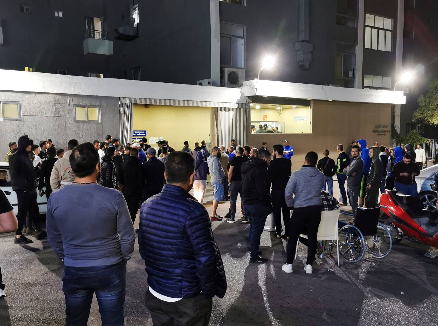 People gather outside a hospital where some of the people injured in the explosion near Sidon are believed to be receiving treatment. Reuters