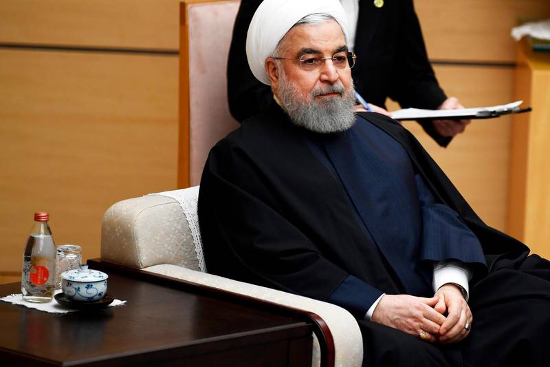 Iranian President Hassan Rouhani attends a meeting with Japanese Prime Minister Shinzo Abe during a meeting at the prime minister's office in Tokyo, Friday, Dec. 20, 2019. (Charly Triballeau/Pool Photo via AP)