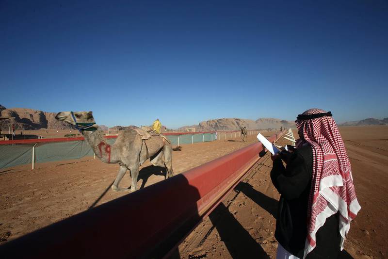 Jordanian Bedouins keep an eye on camels race using robotic jockeys in the desert of Wadi Rum valley, south of Jordan.