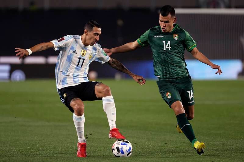 Angel Di María­ of Argentina under pressure from Bolivia's Moisss Villarroel Angulo. Getty