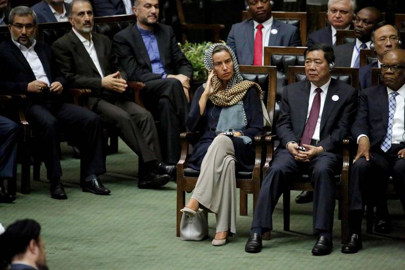 EU foreign policy chief Federica Mogherini, centre, listens as Iran's president delivers a speech after being sworn in before parliament in Tehran. AFP