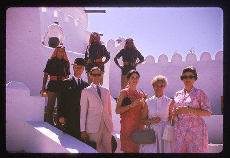 British diplomats and family members visit Al Jahili Fort in October 1966. From left: Archie Lamb (later Sir Archie Lamb) in the dark suit and hat, who was British Political Agent in Abu Dhabi from 1965 until 1968, is pictured with Sir Stewart Crawford, who was the UK's Bahrain-based Political Resident in the Gulf until 1970. Lamb's daughter Elizabeth (centre), his wife Christina, and Crawford's wife, Mary (right), are the other members of the delegation. Courtesy Allela Cochrane-Dyet