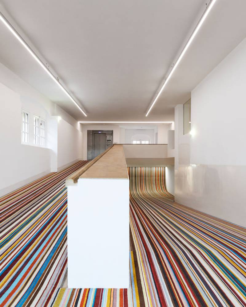 Sloping corridor in the Picasso Museum features carpet in a recognisable Paul Smith stripe