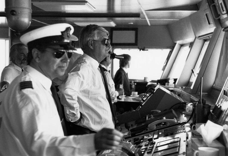 EWR6BT Captain Robin Woodall, Master of the QE2, on the bridge of the ship as it is sailed into Liverpool as part of Cunard's birthday celebrations. Liverpool, 24th July 1990.