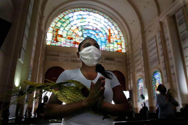 A woman attends Palm Sunday Mass in Caacupe, Paraguay. AP Photo