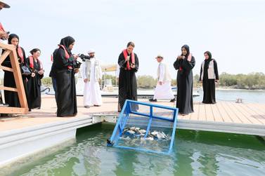 Maryam Al Mehairi and Dr Shaikha Al Dhaheri release the fish into Abu Dhabi waters. Courtesy Environment Agency Abu Dhabi