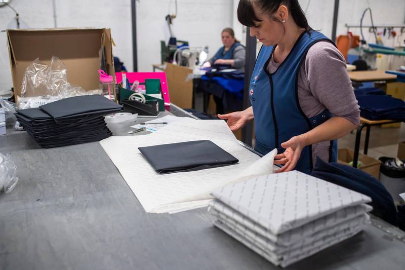 DUKINFIELD, ENGLAND - MARCH 27: A woman packs NHS uniforms as staff at Tibard begin work on a new order of 20,000 nurses uniforms at their factory in Dukinfield where they usually make catering uniforms for the food industry on March 27, 2020 in Dukinfield, England. British Prime Minister, Boris Johnson, announced strict lockdown measures urging people to stay at home and only leave the house for basic food shopping, exercise once a day and essential travel to and from work. The Coronavirus (COVID-19) pandemic has spread to at least 182 countries, claiming over 10,000 lives and infecting hundreds of thousands more. (Photo by Anthony Devlin/Getty Images)