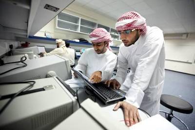 Higher Colleges of Technology students Ali al Braiki, center, and Abdul Aziz al Muhairi, right, work during their megatronics class on Wednesday, Nov. 23, 2011 at the school's campus in Ruwais. (Silvia Razgova/The National)
