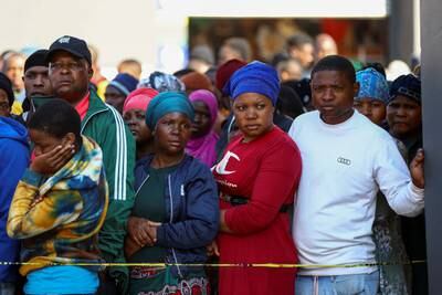 People gather at the scene of the fatal blaze, in South Africa's biggest city. Reuters