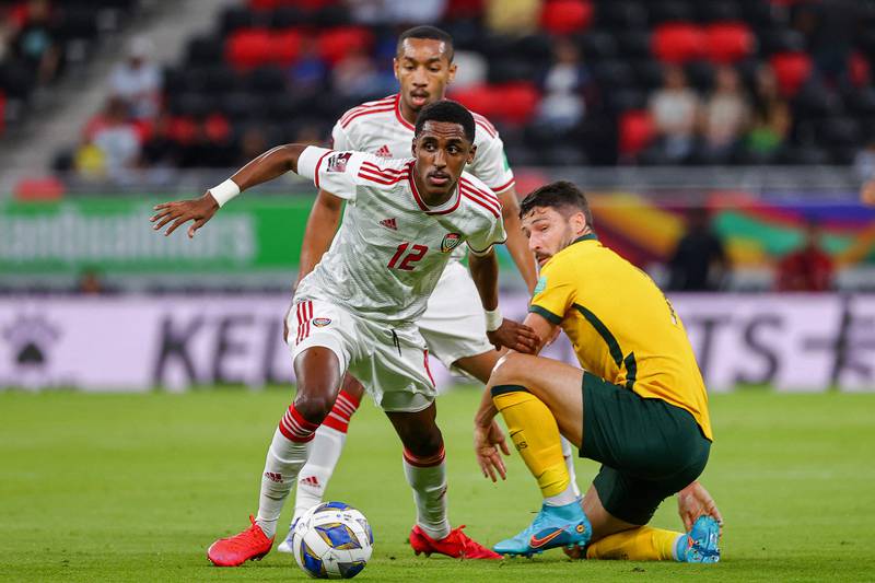 UAE's defender Khalifa Al Hammadi dribbles past Australia's Alex Wilkinson at the Ahmad bin Ali stadium on Tuesday. AFP