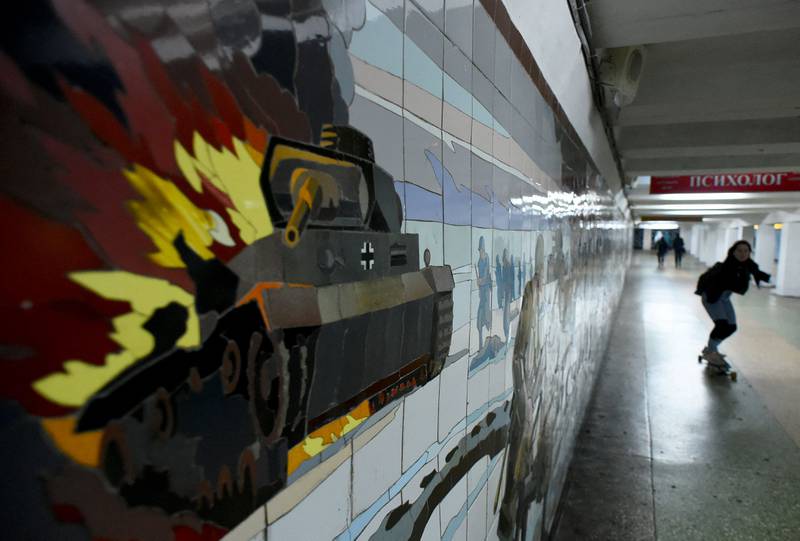 A skateboarder passes a wall decorated with a mosaic depicting a Second World War battle scene in an underground passage in the southern city of Rostov-on-Don, Ukraine. AFP