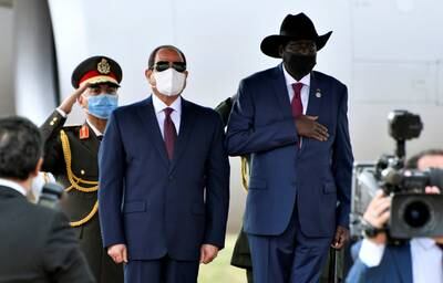 Egypt's President Abdel Fattah al-Sisi and South Sudan's President Salva Kiir, wearing protective face masks, stand as they listen to national anthems in Juba, South Sudan, November 28, 2020. REUTERS/Jok Solomun