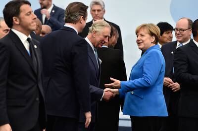 Shaking hands with Angela Merkel, German chancellor at the time, during the Cop21 summit in Paris