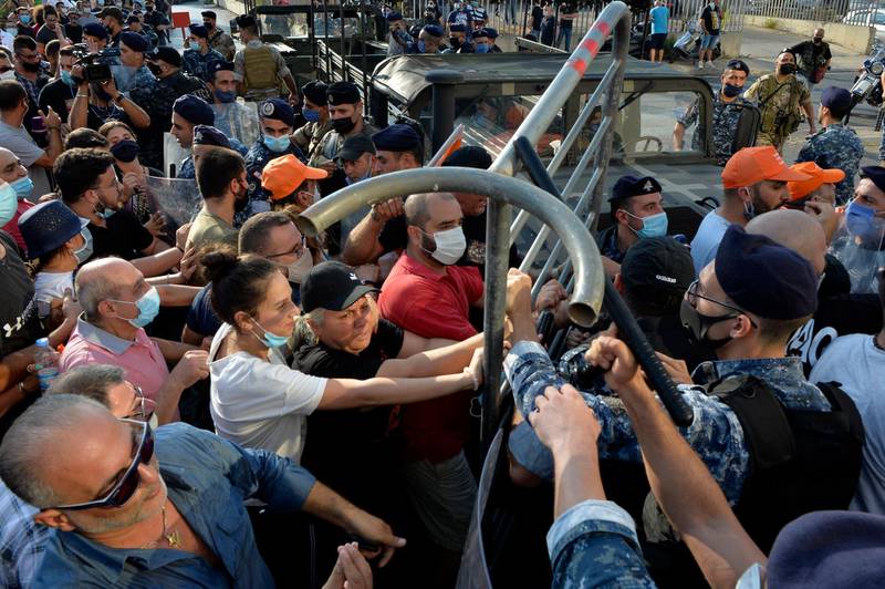 Supporters of Lebanese President Michel Aoun remove barriers before the arrival of the anti-government protesters on the road leading to the Presidential palace in Baabda, east Beirut.  EPA