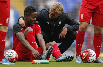 Liverpool manager Jurgen Klopp chats with Divock Origi before they played to a goalless draw against Tottenham on Saturday. John Sibley / Action Images / Reuters / October 17, 2015 